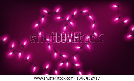 pink fairy lights in heart shape hang on dark background with neon text