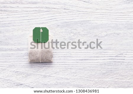 Tea bag on a white wooden table. Close-up