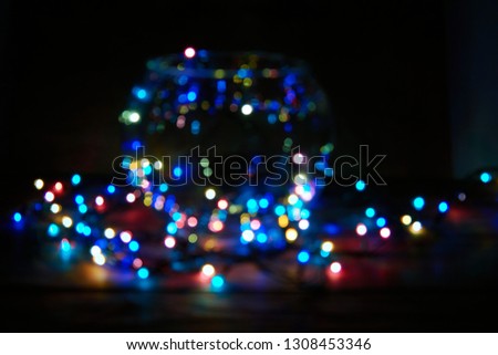                   Multi-color holiday garland. Garland is blurred. Many colorful round lights. Fully defocused photo. Blurred background and foreground             