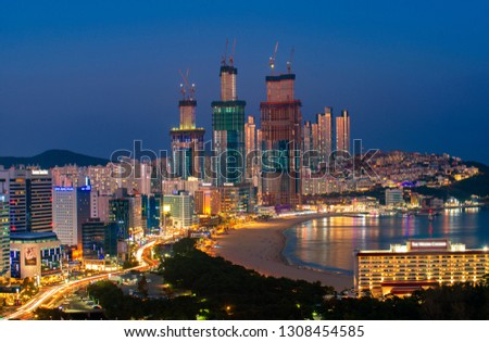 Busan beach view from roof top Busan city in night time with blue sky and full moon, South Korea, this picture can use for tavel, Busa, South Korea and  city concept