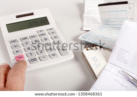 calculator over table with papers