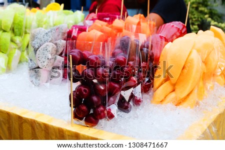 Popular Thai fruits at street food, Pineapple, Watermelon, Dragon fruit, Guava, and Cantaloupe, Creative layout made of fruits, Healthy fruit background, Studio photo of different fruits in ice bucket
