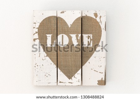 Wall with picture of white wooden boards and painted brown heart