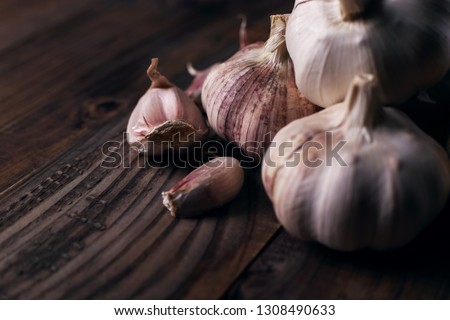 Garlic cloves rustic wooden table. Vitamin healthy food spice image. Spicy cooking ingredient picture.