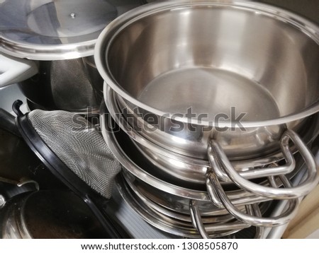 Cooking array of pots and pans stacked in a drawer 