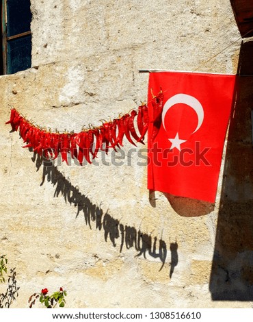 pepper hanging on a rope, on the street, near the flag of Turkey