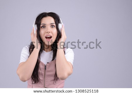 Wonderful cheerful beautiful young caucasian brunette woman found her favourite track in playlist. Internet radio or broadcast podcast listener. 