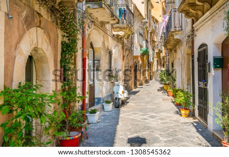 Picturesque street in Ortigia, Siracusa old town, Sicily, southern Italy. Royalty-Free Stock Photo #1308545362