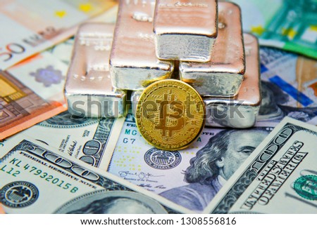 golden bitcoin cryptocurrency against the background of fiat money and precious metals silver