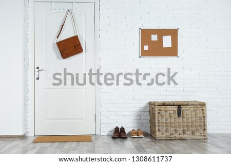Hallway interior with white door and mat Royalty-Free Stock Photo #1308611737