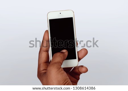 Male hand holding smartphone with blank screen. Isolated on white background.