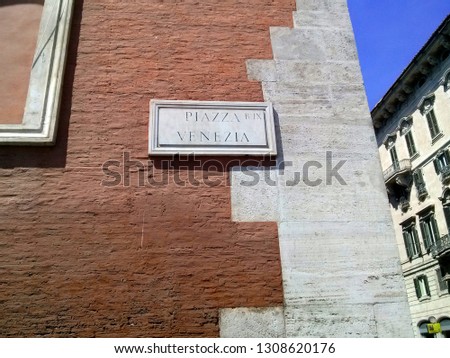 Piazza Venezia sign on brick wall, Rome, Italy. 