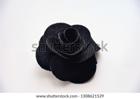 black artificial rose on a white background