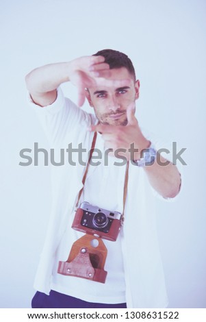 Young man with camera. Isolated over white background.