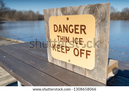 Danger Thin Ice Keep Off Sign at Lake