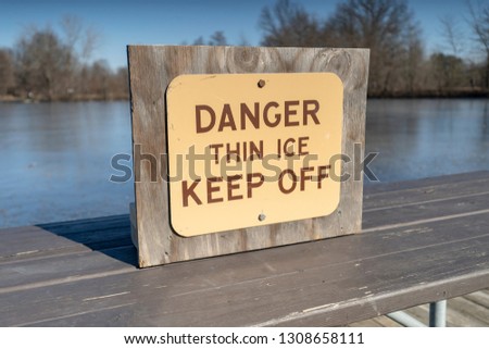 Danger Thin Ice Keep Off Sign at Lake