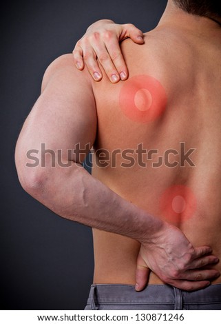 Man with severe back pain holds the shoulder Royalty-Free Stock Photo #130871246