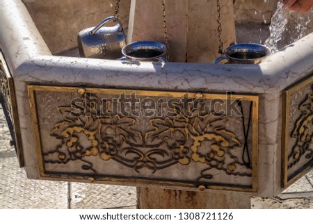 Hands under running water at hand washing station in old city of Jerusalem, Israel