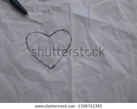 Draw a heart shape by a pen on a wrinkled