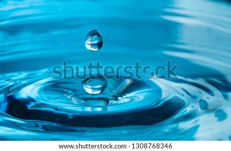 close up of a water drop falling and impact with a body of water Royalty-Free Stock Photo #1308768346