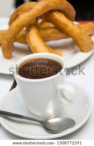 Churros with chocolate served in a cup