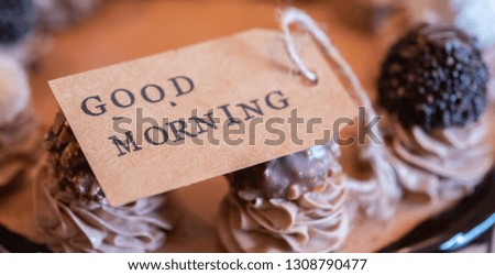 Close up image of GOOD MORNING label on a delicious chocolate cake. Selective focus.
