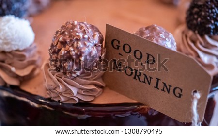 Close up image of GOOD MORNING label on a delicious chocolate cake. Selective focus.
