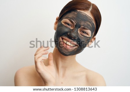 smiling woman in clay mask