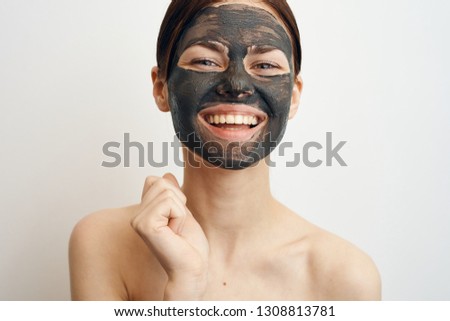 woman in a cosmetic mask is smiling