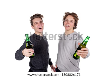 Two happy guys drinking beer and eating chips while watching football game. Isolated on white background