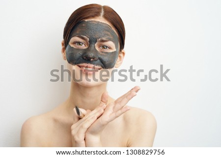 woman in clay mask on face