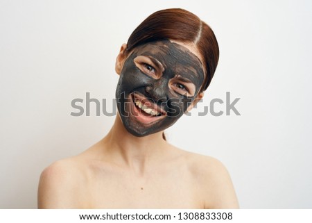 woman smiling in a cosmetic mask