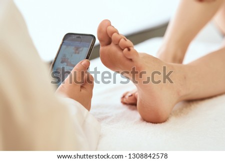   phone takes pictures of foot massage                             