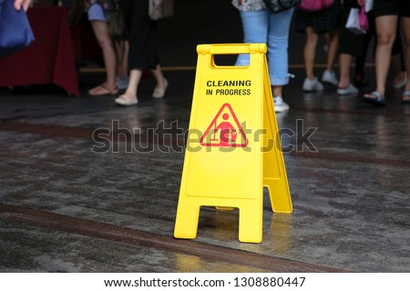 Sign showing warning of caution wet floor in airport.