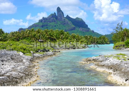 View of the Mont Otemanu mountain reflecting in water over the reef between the ocean and the lagoon in Bora Bora, French Polynesia, South Pacific Royalty-Free Stock Photo #1308891661