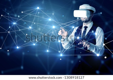 Businessman in virtual reality goggles investigate global network connectivity concept