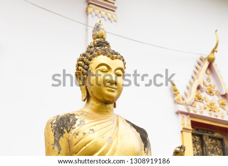 Ancient gold color Buddha statue in northern Thailand's phrae province