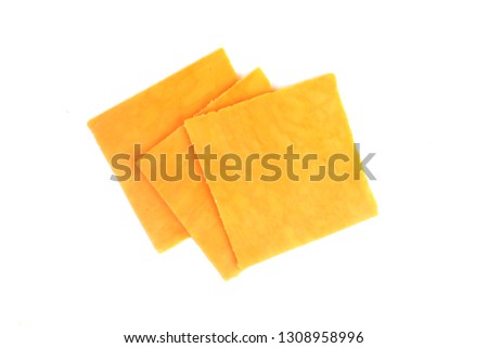 pieces of cheddar cheese on a white background Royalty-Free Stock Photo #1308958996