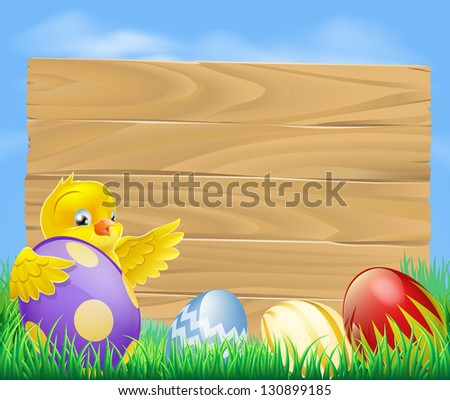 Yellow Easter chicken and chocolate painted Easter eggs with a blank wooden sign for your message