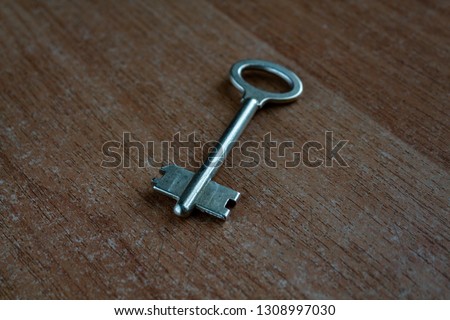 old key on a wooden surface