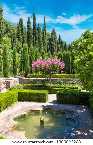 Gardens and fountains in Alhambra palace in Granada in a beautiful summer day, Spain