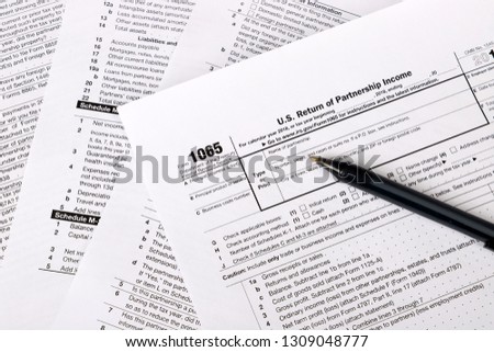 1065 tax form and a pen. US Return for parentship income Royalty-Free Stock Photo #1309048777