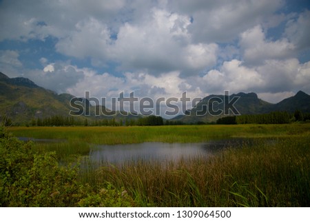 Beautiful outdoor panoramic landscape of mountains and big green lake, Sam Roi Yot, Thailand. Exotic mountain nature photography of Thailand. Mountain in Thailand province with amazing tropical nature