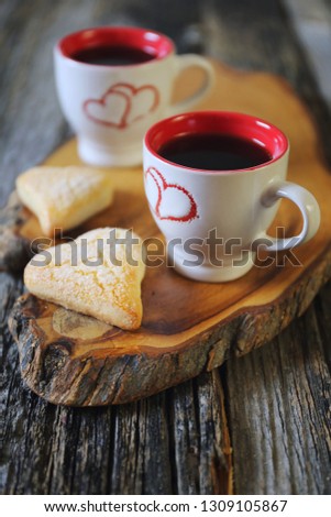 Valentine's Day: two cups of coffee and heart cookies on wooden tray. Toned image
