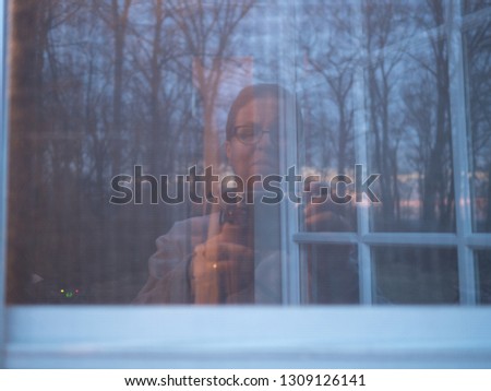 reflection of person in window at sunset