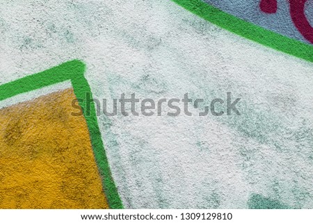 Fragment of colored graffiti painted on a concrete wall. Texture. Abstract background for design.