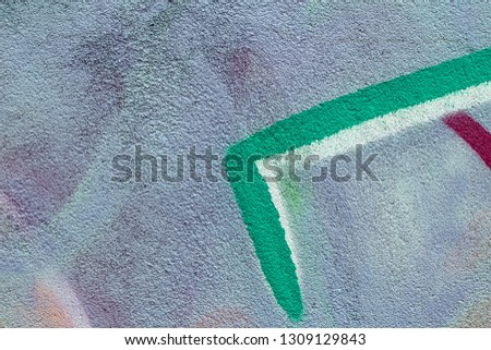 Fragment of colored graffiti painted on a concrete wall. Texture. Abstract background for design.