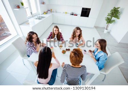 Close up top above high angle view photo beautiful she her ladies group best friends sit round big white table bright kitchen hold cups listen rumours news having fun girls day night holiday indoors