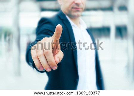 Businessman point finger to camera