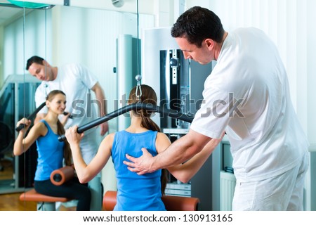 Patient at the physiotherapy making physical exercises with her therapist Royalty-Free Stock Photo #130913165